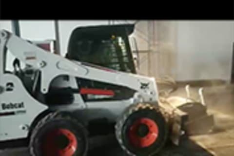 Bobcat Skid-Steer Loader roughening a concrete surface