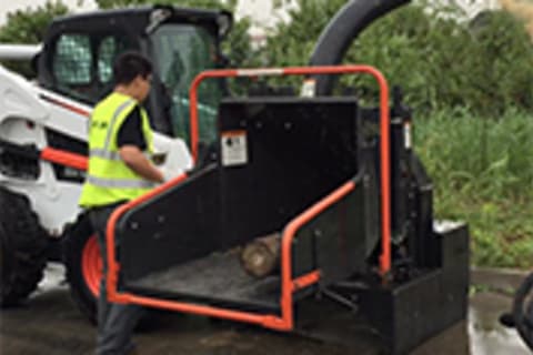 Bobcat S770 Skid-Steer Loader with chipper attachment.