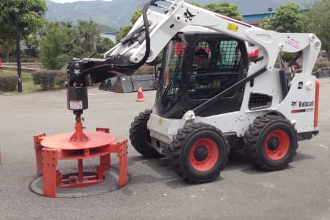 Bobcat S770 Skid-Steer Loader performing milling operation with a planer attachment