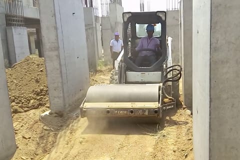 Homeowner driving a Bobcat S16 Skid-Steer with vibratory roller