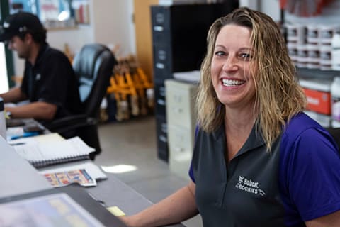 Bobcat employee at work station smiling